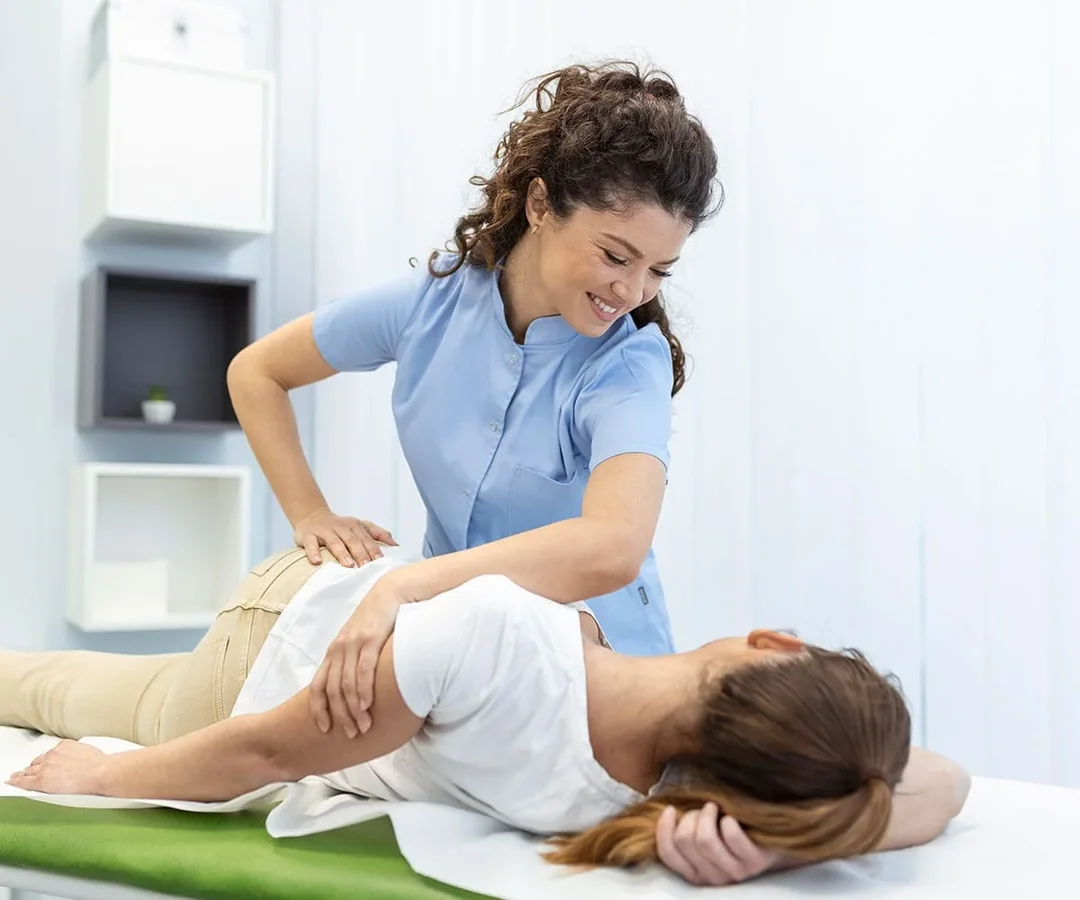 Physiotherapist performing orthopedic manual therapy treatment on a patient. Specialized rehabilitation and movement recovery technique.